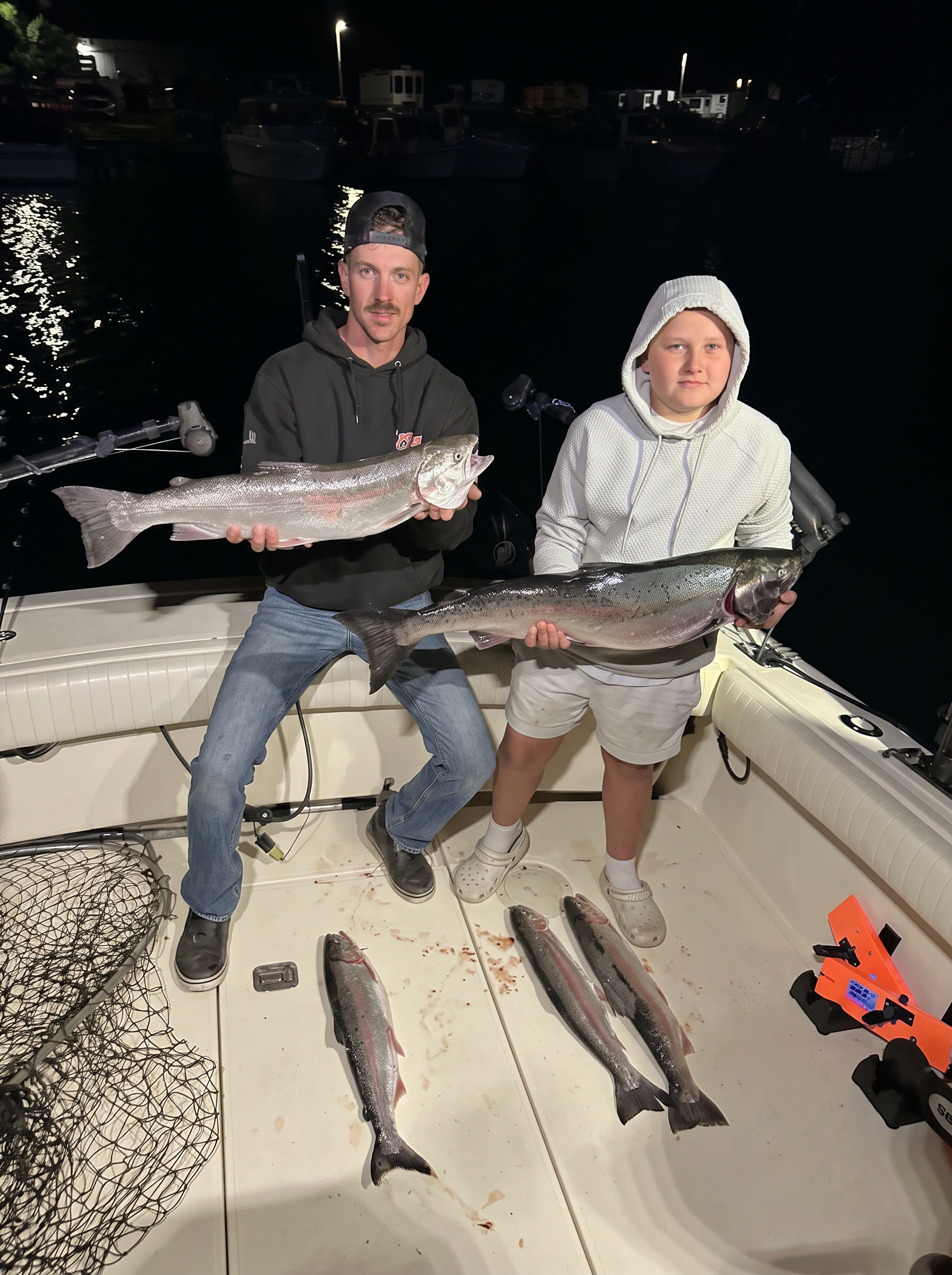 Anglers holding two king salmon after an evening charter